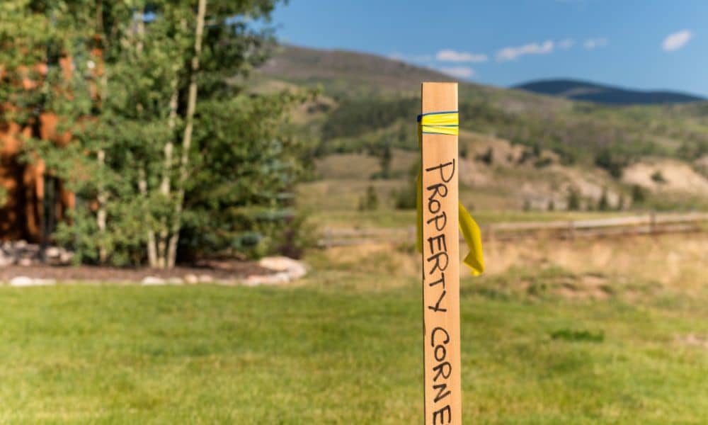 Wooden property corner stake marking property line markers used to identify a land boundary