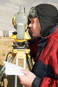 Loan closing surveyor on site - ALTA SURVEY Nashville Licensed land surveyor conducting a loan closing survey with a total station