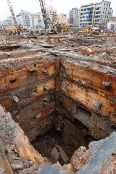 Deep excavation at a construction site showing exposed soil layers and foundation work that emphasize the importance of soil testing in civil engineering
