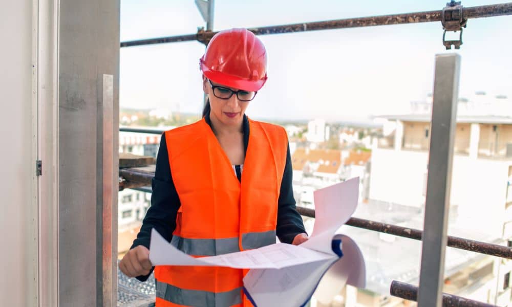 Engineer reviewing site plans before construction to confirm alta title survey details