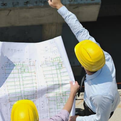 Engineers reviewing commercial site survey plan - ALTA SURVEY Nashville Engineers reviewing a site plan as part of a due diligence survey to identify boundaries, access, and development limits on a commercial property