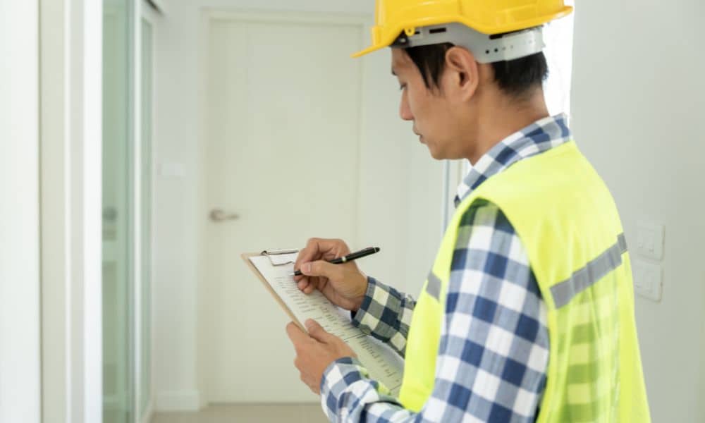 Building site inspection checklist - ALTA SURVEY Nashville Construction engineer inspecting a property and taking notes during a site walkthrough