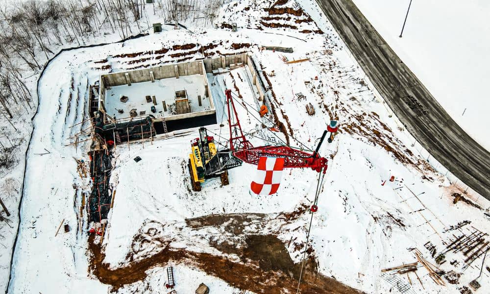 Winter construction site aerial snow grading access road - ALTA SURVEY Nashville Aerial view of a snowy construction site showing grading work, equipment, and access roads planned through land development services
