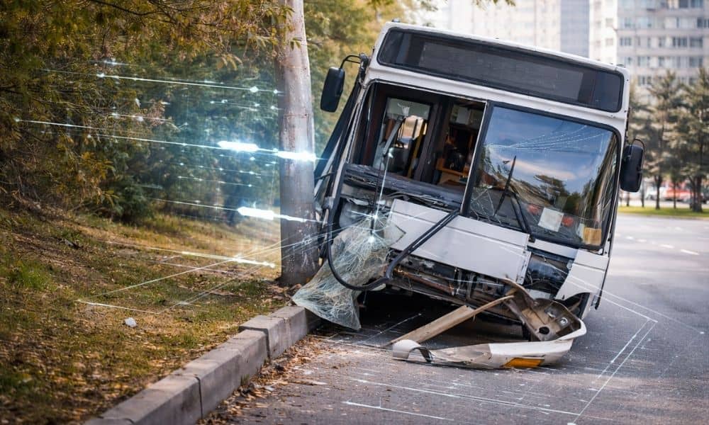 City bus after a crash showing minimal damage to the main frame with overlaid diagrams illustrating structural integrity and energy flow