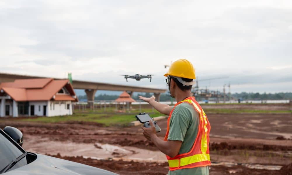 Civil engineer using a drone to survey a construction site and monitor progress